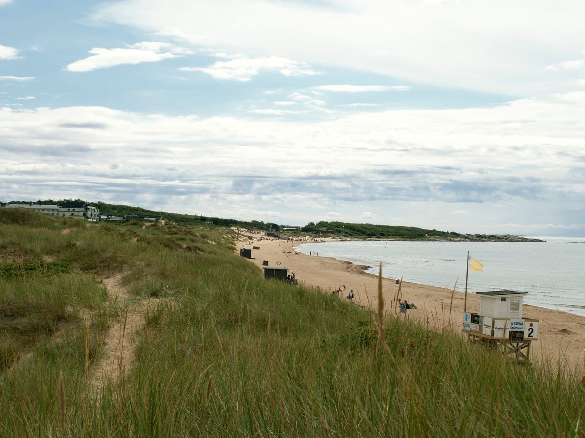 Tylösands strand sedd från sanddynerna, med Hotel Tylösand och Tyludden i bakgrunden